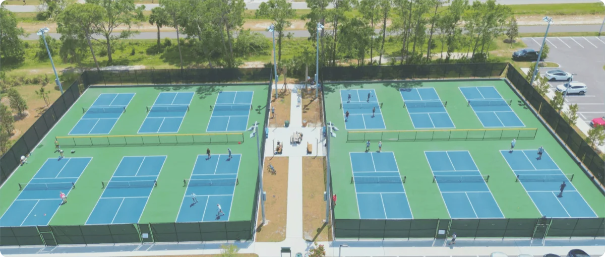 Aerial view of the outdoor pickleball facility with blue courts